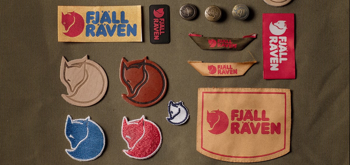 Fjällräven-logo's als patches, emblemen en knopen