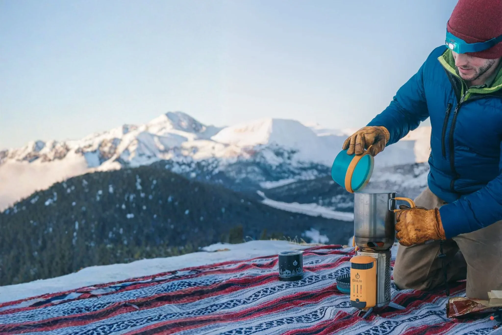 BioLite outdoor kit: power bank, solar panel and head torch on wooden planks